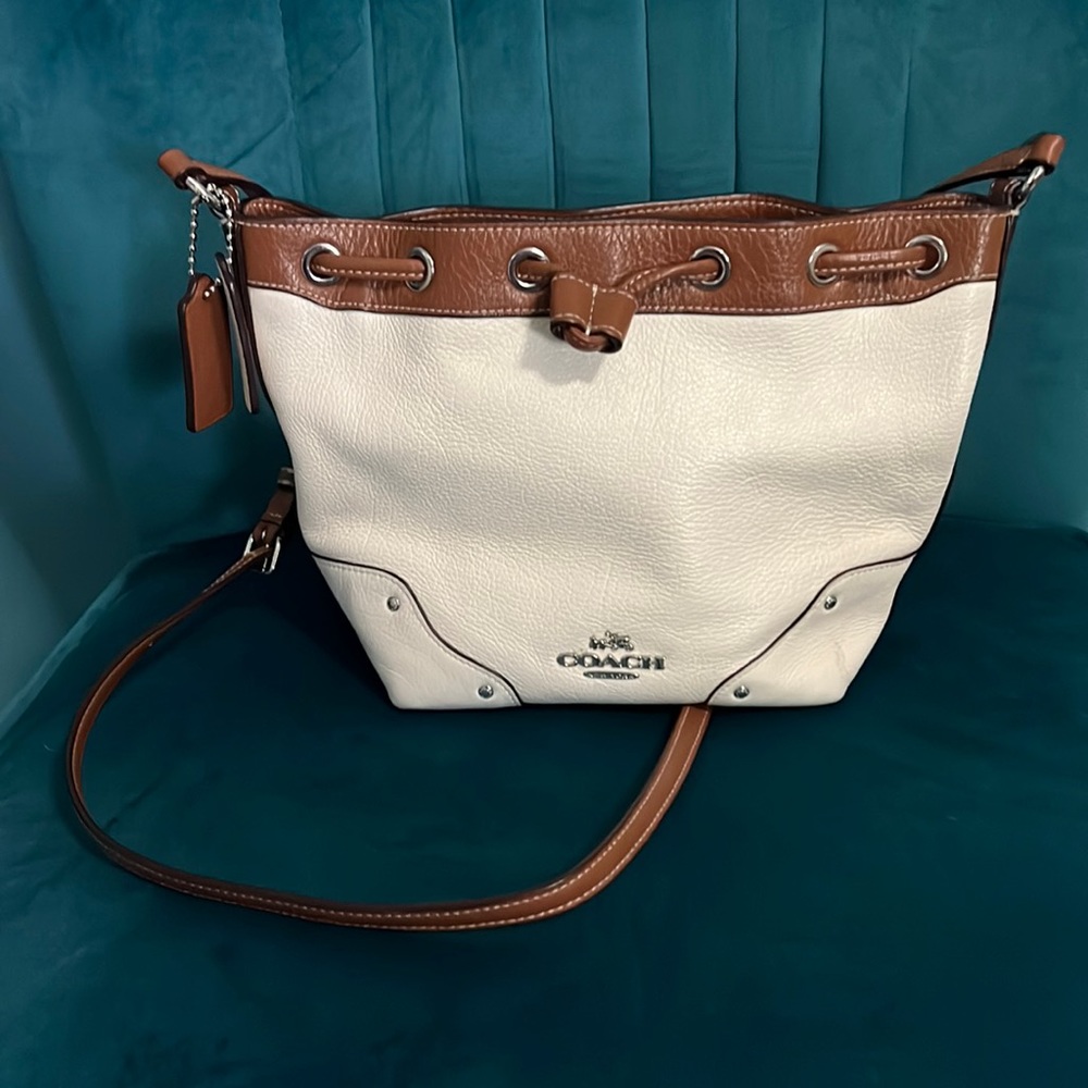 Coach crossbody with adjustable straps, soft leather.